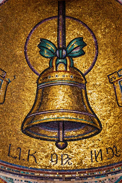 Gold mosaic of the Bell in thousands of glittering tesserae.